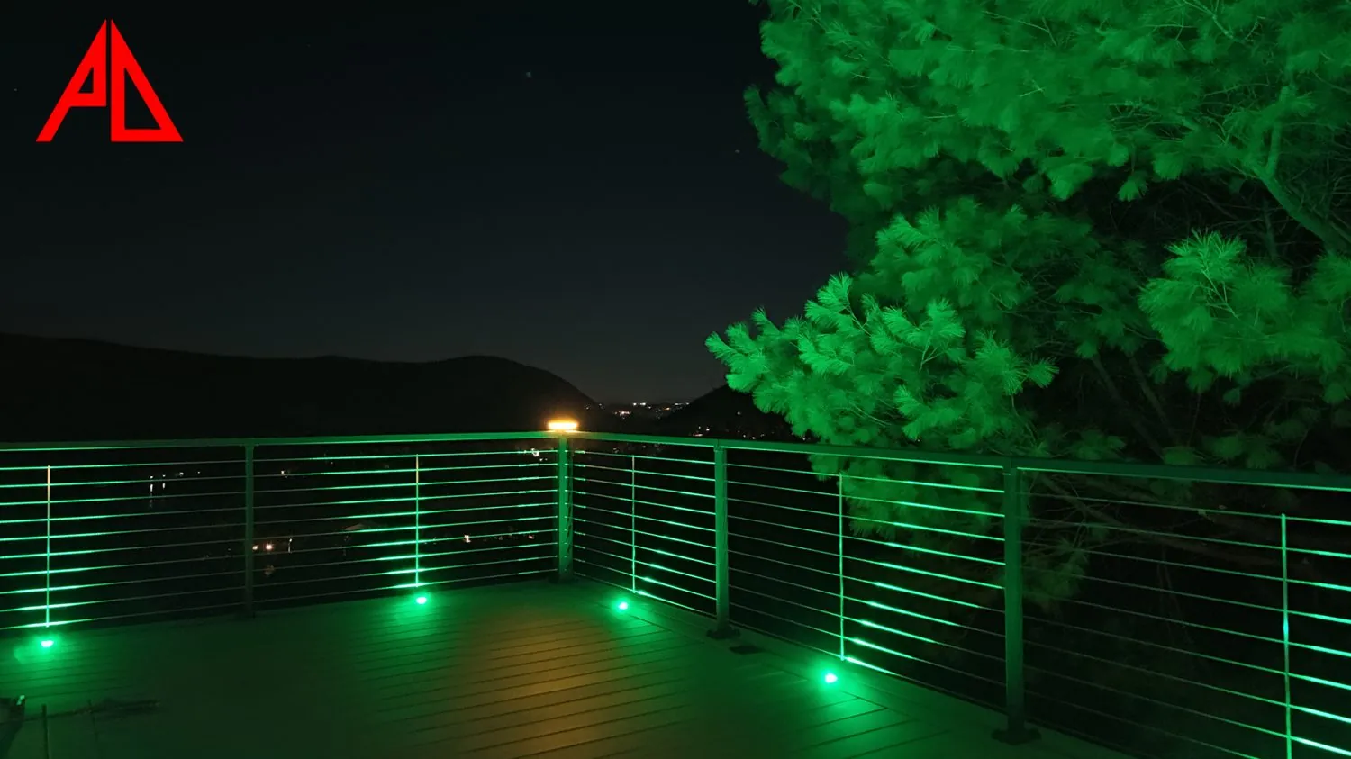Cable rail deck lit at night over a Putnam hillside