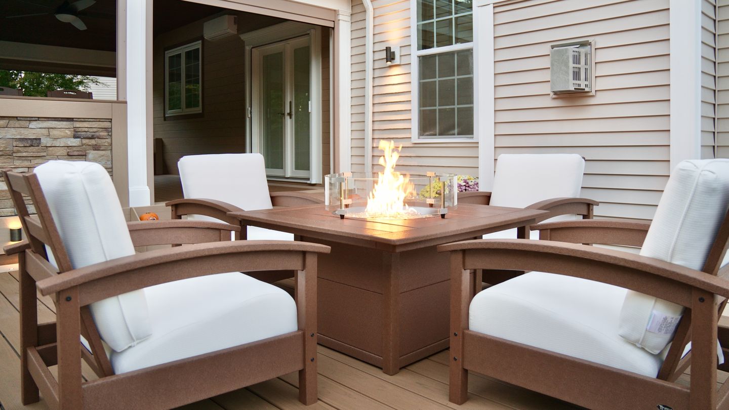 Fire table and lounge on an Orange County deck at night