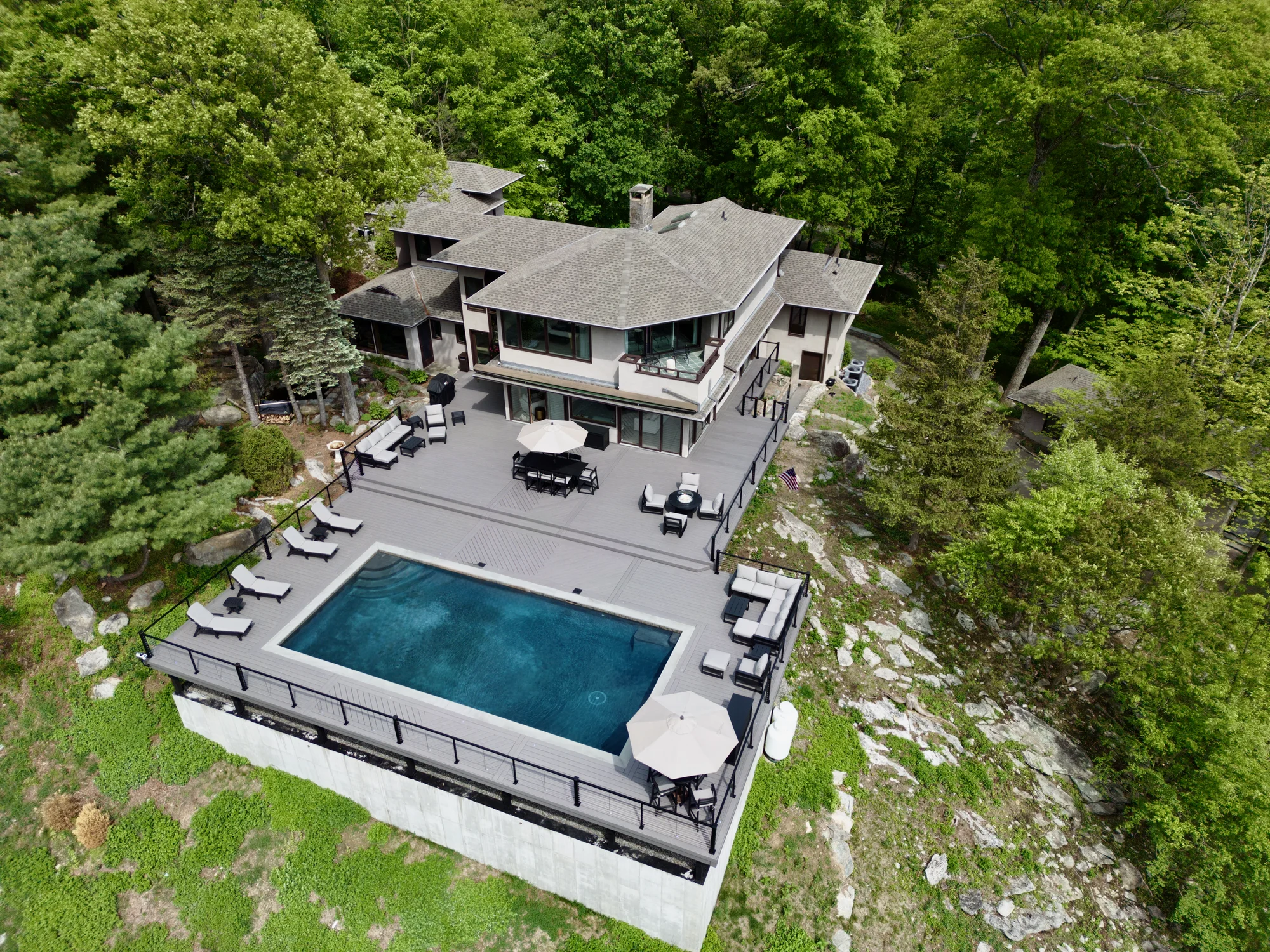 Aerial of the Hudson Horizon Haven estate and multi-level deck above the Hudson River in Garrison, NY
