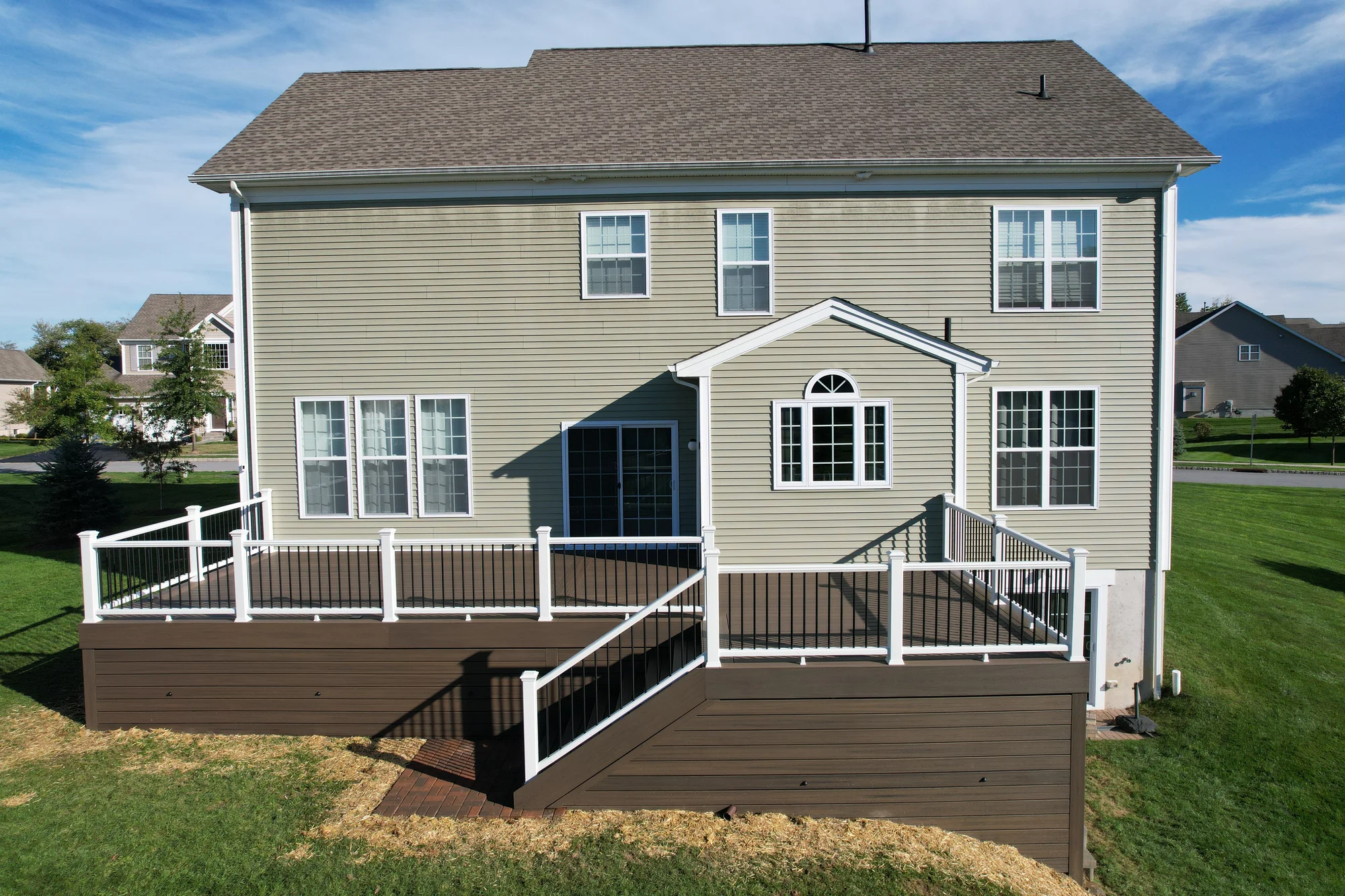 Trex composite deck with a modern white and black railing